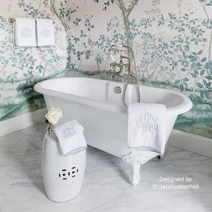 A white bathroom decorated with weezie's light grey monogrammed bath towel.